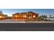 Exterior of house with three-car garage and desert landscaping at sunset at 6208 W Rome Blvd, Las Vegas, NV 89131
