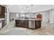 Spacious kitchen features granite island with sink, stainless steel appliances, and open floor plan at 6208 W Rome Blvd, Las Vegas, NV 89131