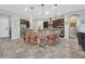 Stylish kitchen with a curved island, pendant lights, stainless steel appliances, and breakfast bar at 6208 W Rome Blvd, Las Vegas, NV 89131