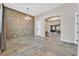 Spacious living area with a stone accent wall, tile floors, and recessed lighting at 6208 W Rome Blvd, Las Vegas, NV 89131