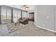 Spacious living room with tiled flooring, bright windows, and a cozy seating arrangement at 6208 W Rome Blvd, Las Vegas, NV 89131