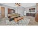 Comfortable living space featuring a wet bar, ceiling fan, and tiled floors for easy maintenance at 6208 W Rome Blvd, Las Vegas, NV 89131