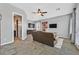 Cozy living room showcasing tiled flooring, a ceiling fan, and a comfortable seating area at 6208 W Rome Blvd, Las Vegas, NV 89131