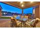 This covered outdoor dining area offers a granite counter, BBQ, and seating with mountain views at 6208 W Rome Blvd, Las Vegas, NV 89131