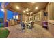 Covered patio with outdoor kitchen, dining area, and ceiling fans at 6208 W Rome Blvd, Las Vegas, NV 89131