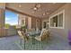 Outdoor patio with a built-in barbecue, a dining table, and comfortable seating for entertaining at 6208 W Rome Blvd, Las Vegas, NV 89131