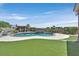 Backyard pool featuring lush artificial grass and privacy landscaping at 6208 W Rome Blvd, Las Vegas, NV 89131