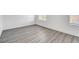 Bright bedroom with gray wood flooring and natural light from the windows at 6346 Azurelyn Ave, Las Vegas, NV 89122