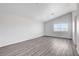 Spacious bedroom with vaulted ceiling, window, and stylish gray wood flooring at 6346 Azurelyn Ave, Las Vegas, NV 89122