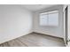 Clean, empty bedroom featuring hard wood floors, one window and one entry door at 6346 Azurelyn Ave, Las Vegas, NV 89122