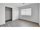 Cozy bedroom with a closet and a bright window with gray wood flooring at 6346 Azurelyn Ave, Las Vegas, NV 89122