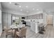 Eat-in kitchen with stainless appliances, gray cabinets, and breakfast bar at 6346 Azurelyn Ave, Las Vegas, NV 89122