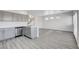 Contemporary kitchen with stainless appliances, gray cabinets, and wood-look flooring at 6346 Azurelyn Ave, Las Vegas, NV 89122
