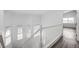 Bright staircase with wood-look floors and white trim, illuminated by three windows at 6346 Azurelyn Ave, Las Vegas, NV 89122