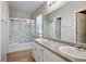 Bathroom with double vanity, granite countertop, shower, and tile floors at 6610 Tumbleweed Ridge Ln # 101, Henderson, NV 89011