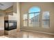 Bright living room featuring a fireplace, large windows, and beautiful wood-look flooring at 6610 Tumbleweed Ridge Ln # 101, Henderson, NV 89011