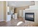 Open-concept living room with a fireplace, tile surround, and wood-look flooring at 6610 Tumbleweed Ridge Ln # 101, Henderson, NV 89011