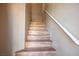 View of a wooden staircase with a white handrail at 6610 Tumbleweed Ridge Ln # 101, Henderson, NV 89011