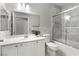 Bright bathroom with a shower over tub, white vanity, and ample lighting at 6635 Caporetto Ln # 204, North Las Vegas, NV 89084