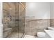 Elegant bathroom featuring a glass shower with marble-like tile and built-in seat at 6635 Caporetto Ln # 204, North Las Vegas, NV 89084