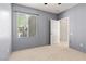 Bedroom with gray walls, carpet, and window with blinds at 6635 Caporetto Ln # 204, North Las Vegas, NV 89084
