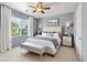 Serene bedroom featuring a tufted headboard, elegant bedside tables, and large windows with natural light at 6635 Caporetto Ln # 204, North Las Vegas, NV 89084