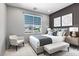 Staged bedroom with window views, stylish decor, and modern furniture at 6635 Caporetto Ln # 204, North Las Vegas, NV 89084