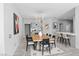 Bright dining area with modern chandelier, stylish table, and bar seating, creating a great gathering space at 6635 Caporetto Ln # 204, North Las Vegas, NV 89084