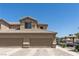 Spacious two-car garage with a well-maintained driveway and landscaped surroundings at 6635 Caporetto Ln # 204, North Las Vegas, NV 89084