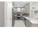 Charming kitchen features stainless steel appliances, gray cabinetry, subway tile backsplash, and stylish quartz countertops at 6635 Caporetto Ln # 204, North Las Vegas, NV 89084