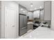 Bright kitchen showcasing stainless steel appliances, sleek gray cabinets, and a striking quartz countertop at 6635 Caporetto Ln # 204, North Las Vegas, NV 89084