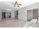 Open-concept living room with modern lighting, light floors, and a sliding glass door at 6635 Caporetto Ln # 204, North Las Vegas, NV 89084