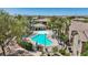 The community pool is surrounded by lounge chairs and umbrellas, perfect for residents to unwind and socialize at 6635 Caporetto Ln # 204, North Las Vegas, NV 89084