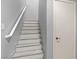 Clean, well-lit staircase with modern white railings and neutral walls leading upstairs at 6635 Caporetto Ln # 204, North Las Vegas, NV 89084
