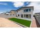 Landscaped backyard with green turf, patio space, and secure block wall offering a private outdoor experience at 681 Stone Hammer Ave, Las Vegas, NV 89183