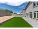 Spacious backyard features lush turf, a block wall, and patio offering relaxation and outdoor enjoyment at 681 Stone Hammer Ave, Las Vegas, NV 89183
