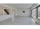 Bright living room featuring tile flooring, a partial wall with staircase view, and sliding door access to backyard at 681 Stone Hammer Ave, Las Vegas, NV 89183