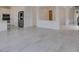 Spacious living area with open floor plan, tile flooring, and access to the kitchen and other rooms at 681 Stone Hammer Ave, Las Vegas, NV 89183