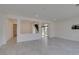 Bright living room showcasing tile floors, partial walls to other rooms, and a backyard patio slider at 681 Stone Hammer Ave, Las Vegas, NV 89183
