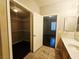 Bathroom with dual sink vanity, closet, and access to the primary bedroom at 7135 S Durango Dr # 106, Las Vegas, NV 89113