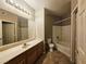 Bathroom with a large mirror, wood cabinets, and a bathtub at 7135 S Durango Dr # 106, Las Vegas, NV 89113
