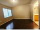 The primary bedroom is spacious with wood floors and natural light at 7135 S Durango Dr # 106, Las Vegas, NV 89113