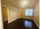 Bright bedroom with wood floors featuring an ensuite bathroom and closet at 7135 S Durango Dr # 106, Las Vegas, NV 89113
