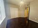 Bedroom showcasing hardwood floors, natural light, and closet with double doors at 7135 S Durango Dr # 106, Las Vegas, NV 89113