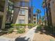 A view of the exterior featuring lush landscaping and architecture at 7135 S Durango Dr # 106, Las Vegas, NV 89113