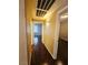 Hallway featuring hardwood floors and neutral walls leading to rooms with natural light at 7135 S Durango Dr # 106, Las Vegas, NV 89113