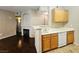 Kitchen with tiled floors, breakfast bar and open access to the living room with a fireplace at 7135 S Durango Dr # 106, Las Vegas, NV 89113