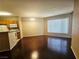 Open-concept living and dining area with hardwood floors and modern lighting at 7135 S Durango Dr # 106, Las Vegas, NV 89113