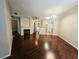 Inviting living room featuring a fireplace and hardwood floors, seamlessly flowing into the kitchen area at 7135 S Durango Dr # 106, Las Vegas, NV 89113