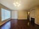The living room features hardwood floors, a fireplace, and a large window for natural light at 7135 S Durango Dr # 106, Las Vegas, NV 89113
